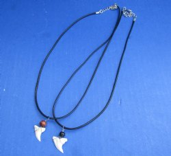 Wholesale Assorted white colored shark tooth with bead on 18" black cord necklace. 25 pcs @ $1.60 each; 50 pcs @ $1.44 each