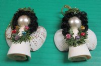 Wholesale Strombus and Cockle shell angel with black hair and green garland necklace ornament - 2-1/2 inches long - Packed: 10 pcs @ $1.60 each; Packed: 30 pcs @ $1.40 each